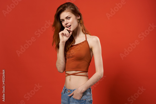 cheerful pretty woman in red t-shirt and jeans attractive look glamor fashion hipster © SHOTPRIME STUDIO