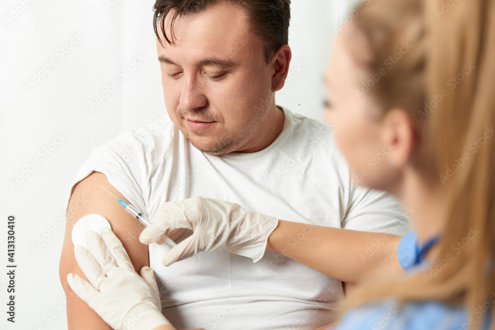 woman doctor injecting man into arm health hospital covid vaccination woman doctor injecting man into arm health hospital covid vaccination
