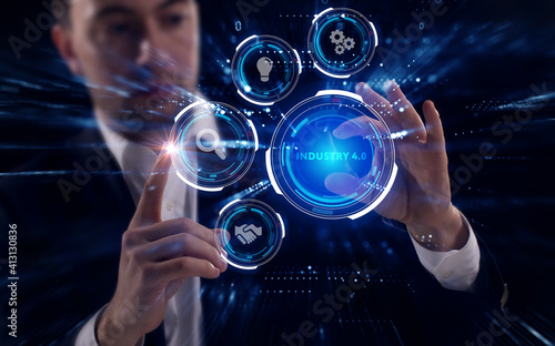 Business  Technology  Internet and network concept. Young businessman working on a virtual screen of the future and sees the inscription  Industry 4.0