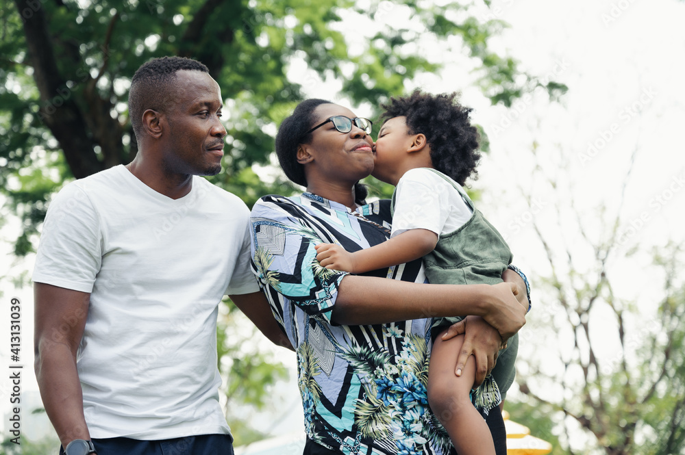Happy black people family in garden with son kiss mom Happy black people family in garden with son kiss mom