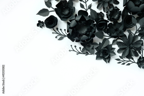 Black paper flowers on white background. Cut from paper.