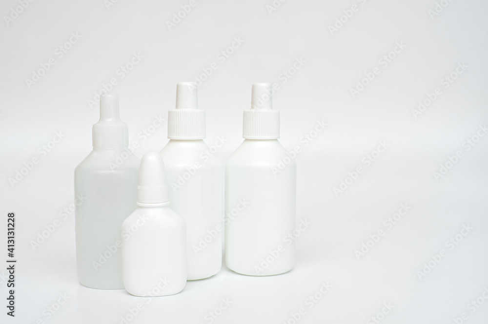 White plastic bottles of medicines on neutral background White plastic bottles of medicines on neutral background