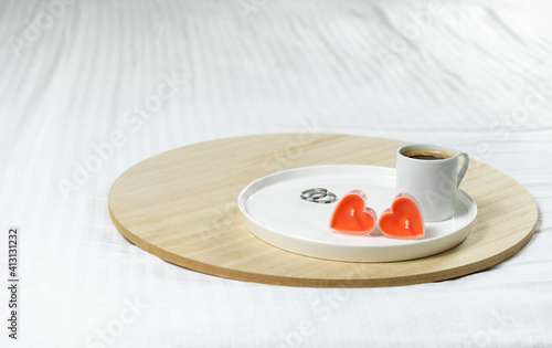 Image of Valentine's day composition. coffee in white bed valentin day with candles in the form of a heart. 14 February, women's day, March 8.