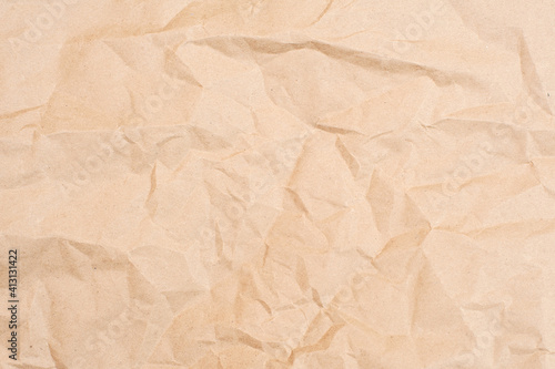 Crumpled brown paper texture. Brown background