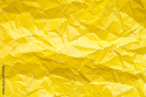 Crumpled yellow paper texture. Yellow background 