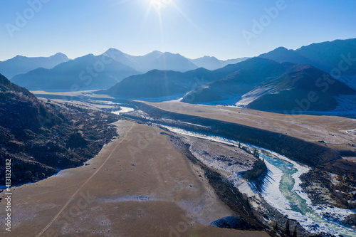 Aerial view of Katun river and Ilgumen rapid on sunny winter day. Altai Republic, Siberia, Russia.