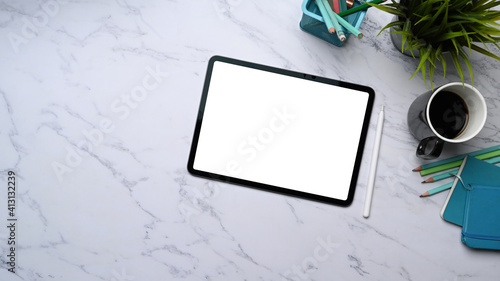 Fototapeta Naklejka Na Ścianę i Meble -  Overhead shot of digital tablet with white screen, stylus pen, coffee cup and stationery on marble table.