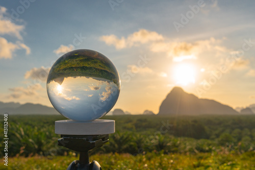 Fototapeta Naklejka Na Ścianę i Meble -  view of sunrise at Samed Nang Chee viewpoint inside the crystal ball. Samed Nang Chee viewpoint is popular landmark in Phang Nga province Thailand.when you on the mountain you can see a lot of islands