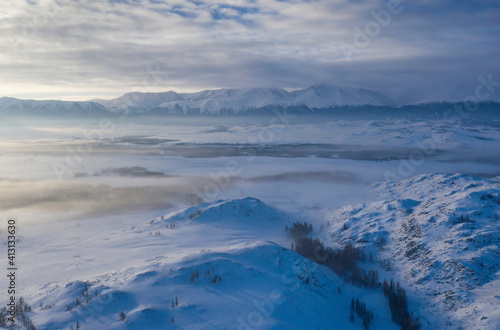 Aerial view of misty Kuray steppe in winter. Altai Republic  Siberia  Russia..