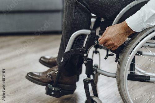 Unrecognizable man sitting in wheelchair close up