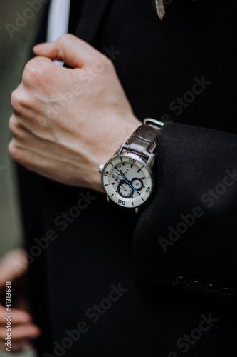 businessman holding watch