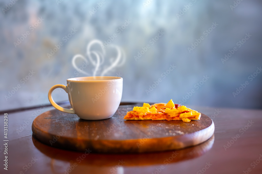 Coffee and small pizza on a wooden plate in a cafe.Photo select focus. Coffee and small pizza on a wooden plate in a cafe.Photo select focus.
