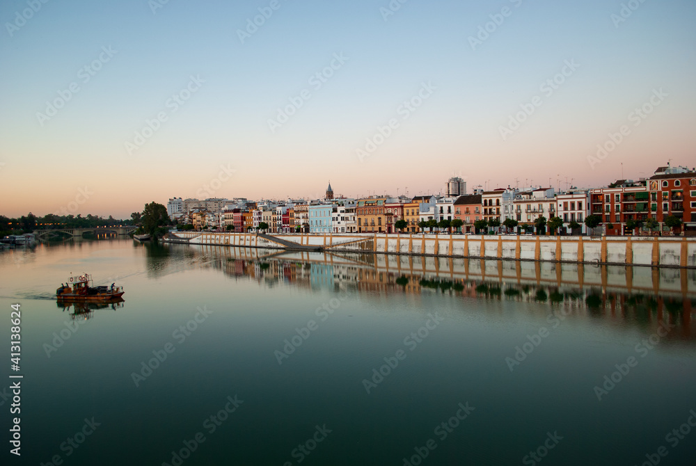 early morning in the district of triana in seville along the guadalquivir