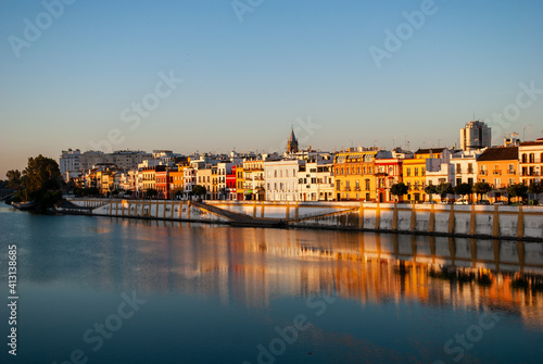 the Triana neighborhood reflected on the Guadalquivir River in Seville, Spain photo