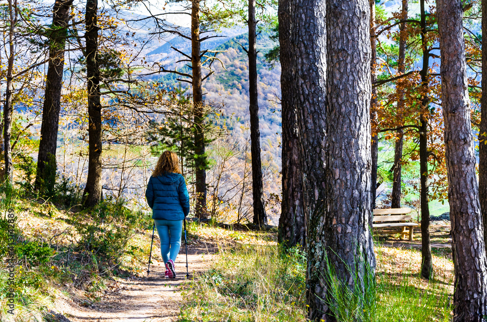 Blonde woman with curly hair, walking through the forests of the Ribes de Freser Valley in the Ripolles region, Girona, Catalonia Blonde woman with curly hair, walking through the forests of the Ribes de Freser Valley in the Ripolles region, Girona, Catalonia