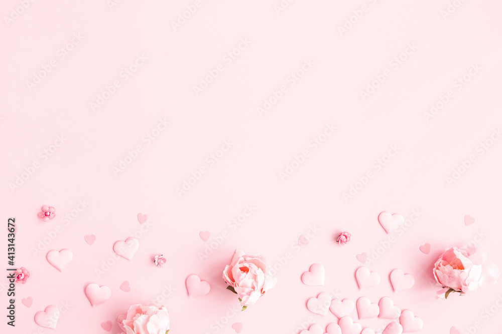 Valentine's Day background. Frame made of pink flowers, hearts on pastel pink background. Valentines day concept. Flat lay, top view, copy space Valentine's Day background. Frame made of pink flowers, hearts on pastel pink background. Valentines day concept. Flat lay, top view, copy space