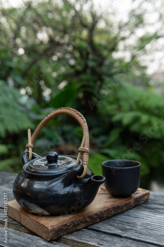 Black Japanese tea cup on wooden background,