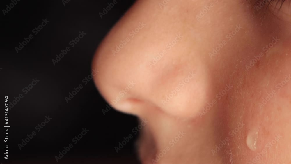 Close-up of a kids cheek with a tear sliding down it. A tear slowly descends on the distressed face of a young boy, macro. High quality 4k footage Close-up of a kids cheek with a tear sliding down it. A tear slowly descends on the distressed face of a young boy, macro. High quality 4k footage