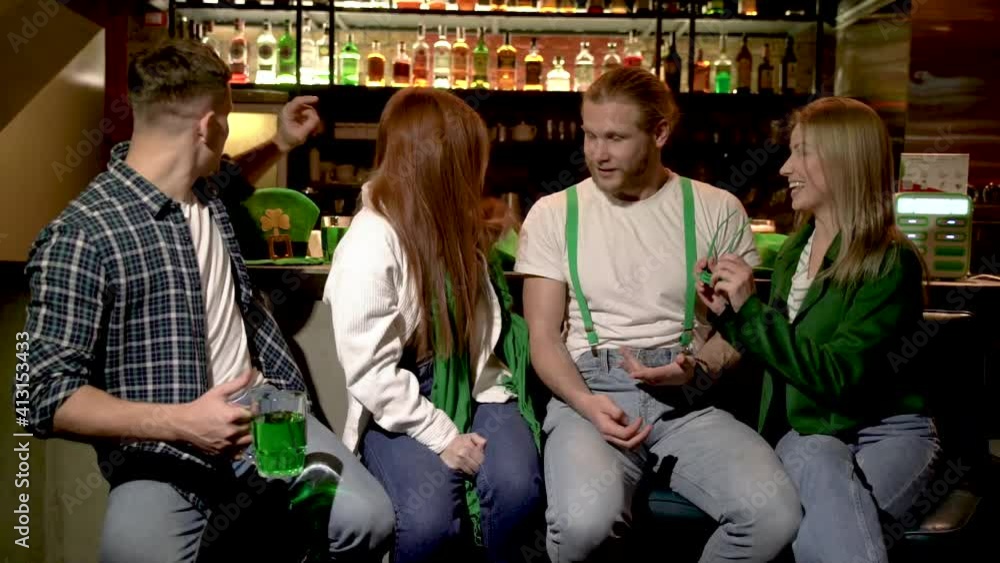 custom made wallpaper toronto digitalThe company of young people celebrate St. Patrick's Day. They have fun at the bar. Friends are dressed in carnival headgear