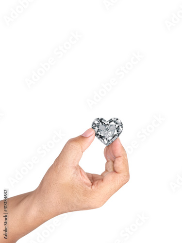 Hand holding heart shaped diamond isolated on white background