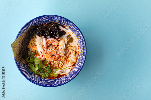 Closeup on asian ebi ramen noodle soup with mushrooms and shrimp photo