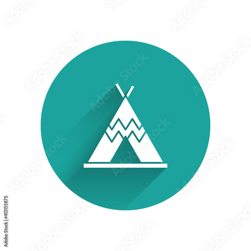 White Traditional indian teepee or wigwam icon isolated with long shadow. Indian tent. Green circle button. Vector.