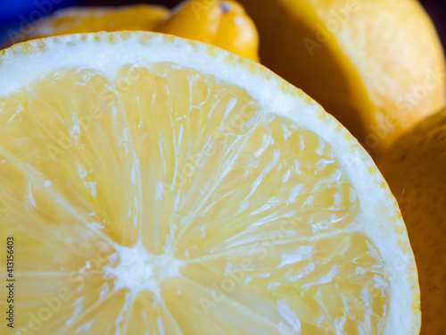 Closeup view of a lemon with others in background
