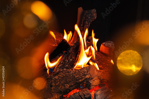 Wood logs burning in fireplace close up