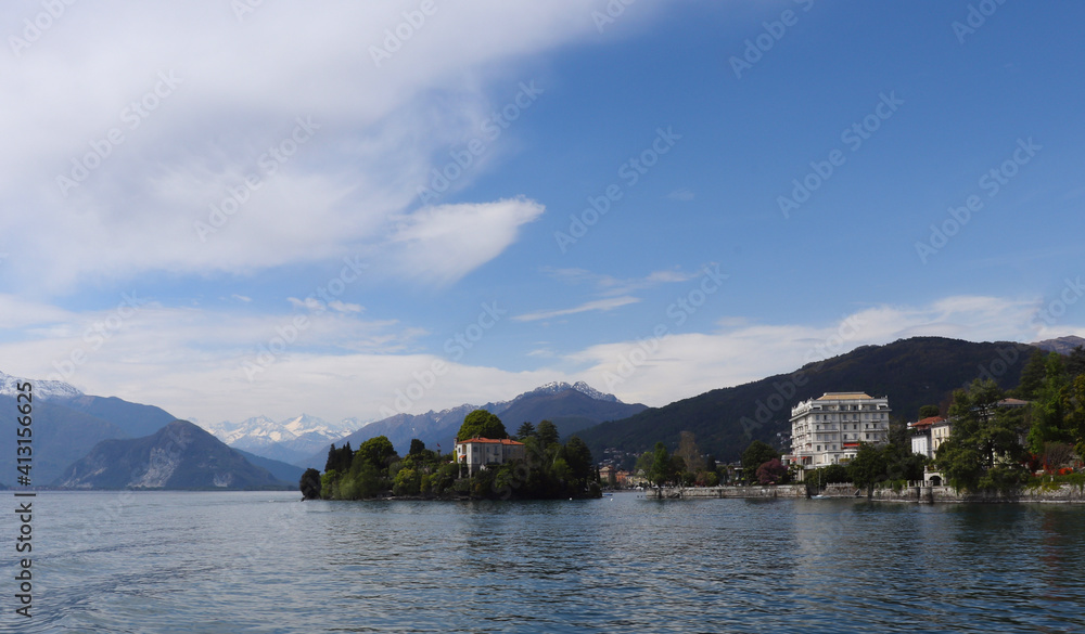 Scenic morning landscape on Lake Maggiore, panorama of coastline hills and Alps mountain ranges in the background, Italy