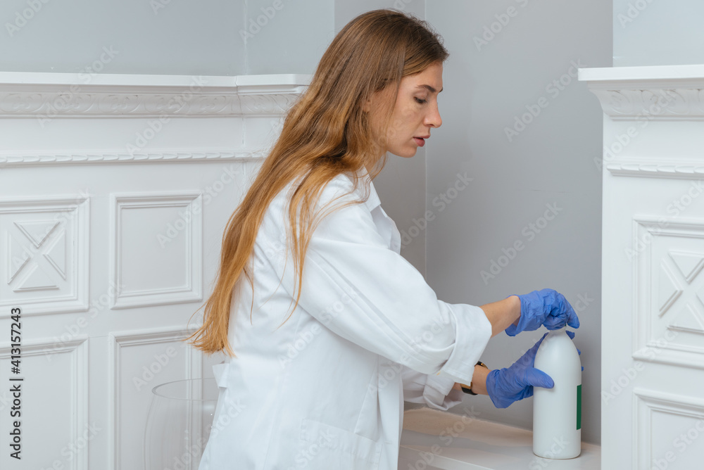 Young female medical worker puts on disposable gloves Young female medical worker puts on disposable gloves