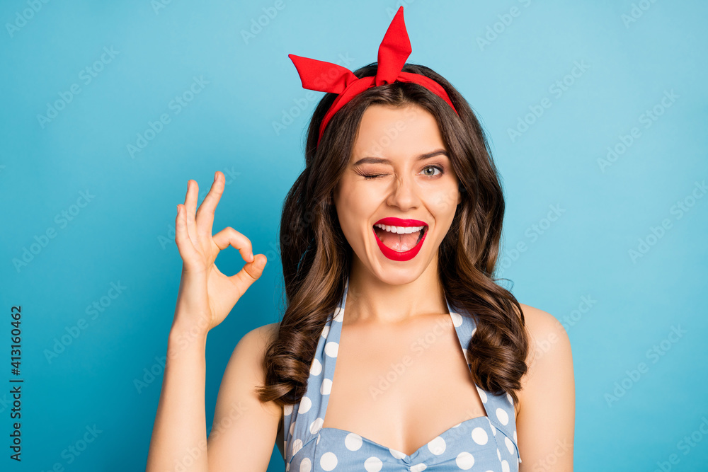 Close-up portrait of her she nice attractive lovely cute charming glamorous cheerful cheery wavy-haired girl showing ok-sign winking isolated over bright vivid shine vibrant blue color background Close-up portrait of her she nice attractive lovely cute charming glamorous cheerful cheery wavy-haired girl showing ok-sign winking isolated over bright vivid shine vibrant blue color background