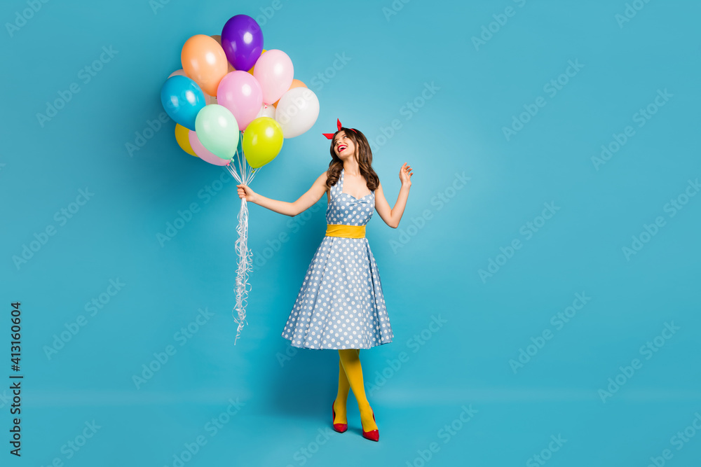 Full length body size view of her she nice attractive lovely winsome fashionable cheerful wavy-haired girl holding air balls having fun isolated on bright vivid shine vibrant blue color background Full length body size view of her she nice attractive lovely winsome fashionable cheerful wavy-haired girl holding air balls having fun isolated on bright vivid shine vibrant blue color background