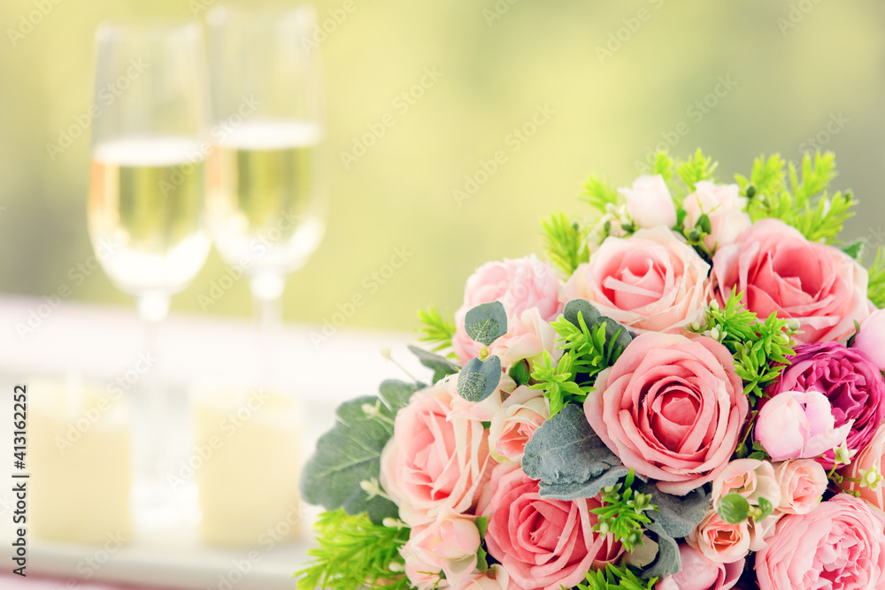 Sweet color rose bouquet with two glasses of wine, love, dating and anniversary concept Sweet color rose bouquet with two glasses of wine, love, dating and anniversary concept