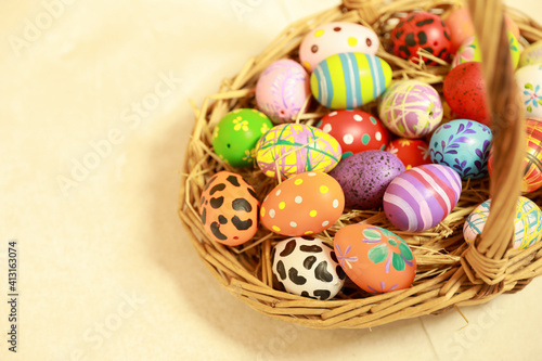 Group of easter eggs painted with handmade and bright color in basket