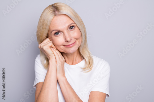 Photo of retired dreamy peaceful old lady palm cheekbone wait wear white t-shirt isolated grey color background