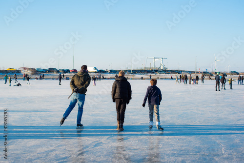 people enjoy ice skating. in zeewolde near Tulpeiland. profitable conditions. frozen lake. on a sunny day. flevoland the netherlands 11 Feb 2021 photo