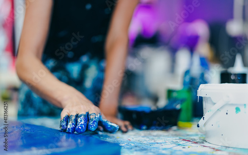 Woman artist painting with hands on canvas in workshop studio - Painter work and creative craft concept