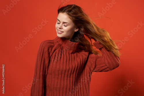 cheerful woman in yellow sweater fashion hairstyle smile casual wear studio red background