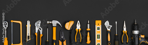 Wallpaper Mural Various working instruments set arranged in line on dark background Torontodigital.ca