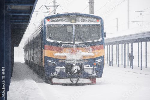 LVIV, UKRAINE - FEBRUARY 10, 2021 :The train is waiting for departure at the station, around a lot of snow. 