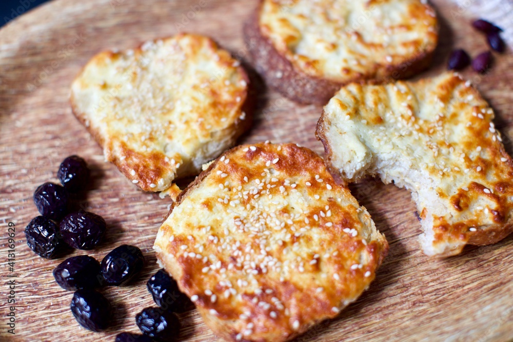 Toast with cheddar cheese and sesame seeds on a wooden tray. breakfast and snack Toast with cheddar cheese and sesame seeds on a wooden tray. breakfast and snack