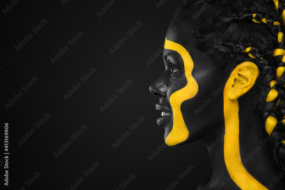Yellow and black body paint. Woman with face art. Young girl with colorful  bodypaint. An amazing afro american model with makeup. Stock Photo by  ©MikeOrlov 447492266