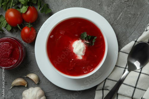 Concept of tasty eating with borscht on gray background