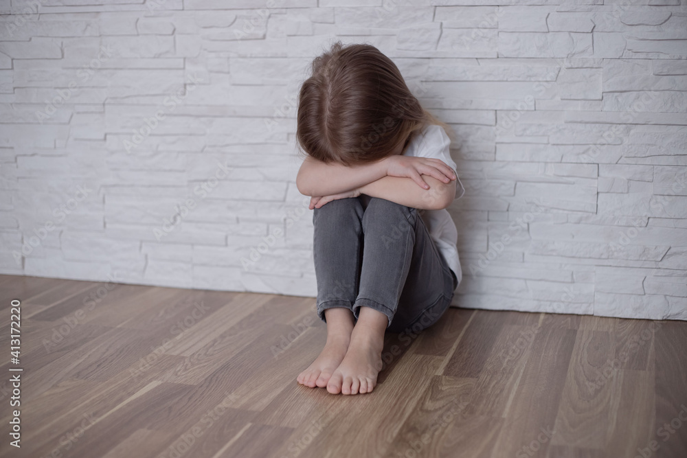 Upset girl sitting on the floor at home. Upset girl sitting on the floor at home.