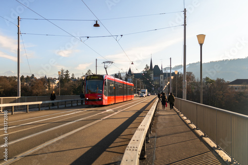 Bern red tram and people on the bridge