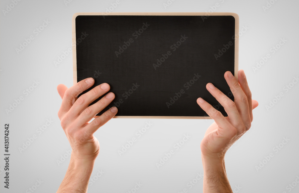 Two hands catching blackboard isolated gray background Two hands catching blackboard isolated gray background
