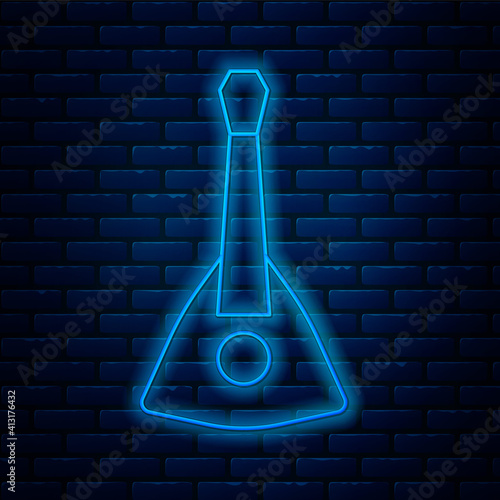 Glowing neon line Musical instrument balalaika icon isolated on brick wall background. Vector.