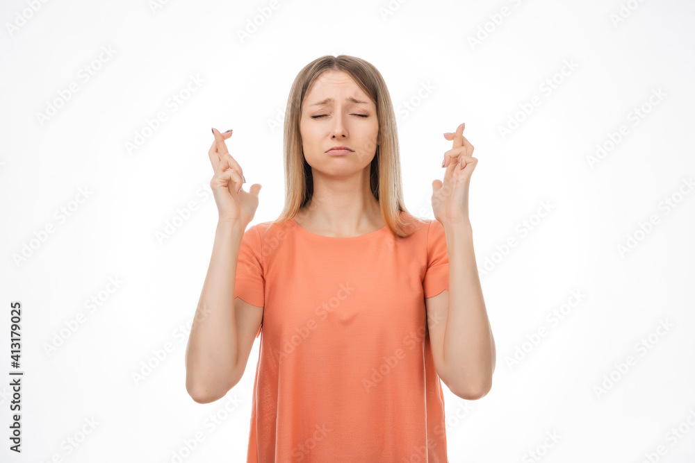 Attractive blond girl cross fingers good luck, praying for wish come true. Human emotions, gesture concept Attractive blond girl cross fingers good luck, praying for wish come true. Human emotions, gesture concept
