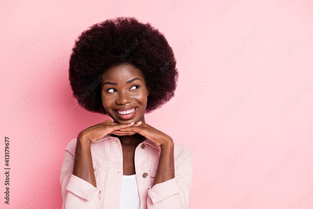 Close-up portrait of pretty cheerful creative minded wavy-haired girl looking aside copy space isolated over pink pastel color background