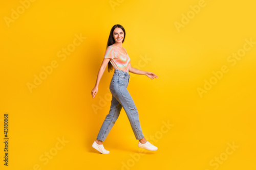 Fototapeta Naklejka Na Ścianę i Meble -  Full length body size side profile photo of pretty girl going hurrying up on meeting isolated on bright yellow color background